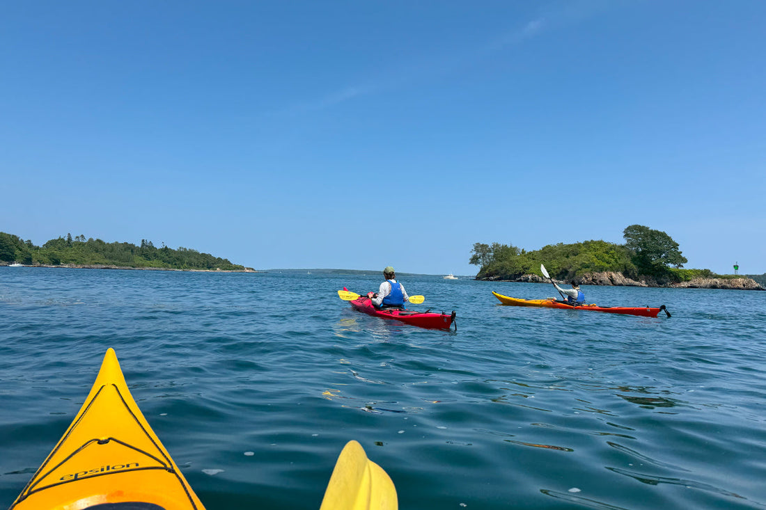 Kayakers paddling across Casco Bay
