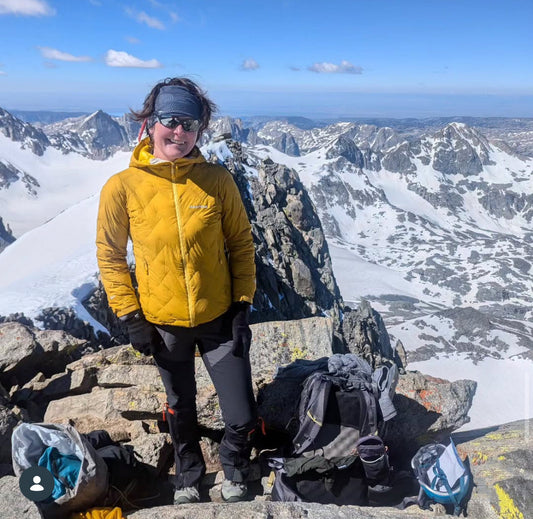 Heather Anderson standing on a snowy mountain summit during a thru-hike — Good To-Go Ambassador